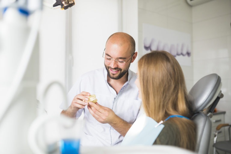 Dentist talking to patient