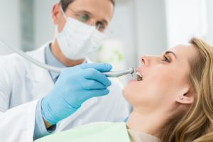 dentist cleaning woman's teeth dentistry