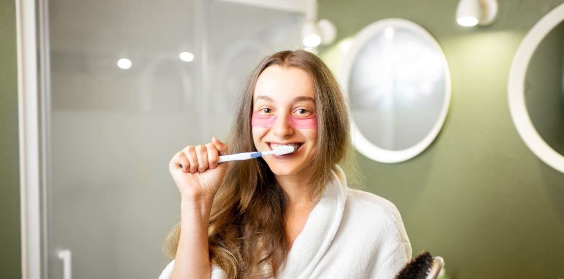 teeth care demonstrated by a white woman brushing her teeth