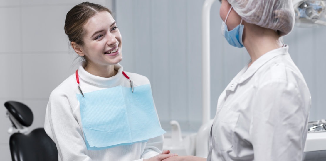 patient shaking hand with dentist