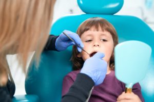 child being examined by a dentist in a paediatric dentistry appointment