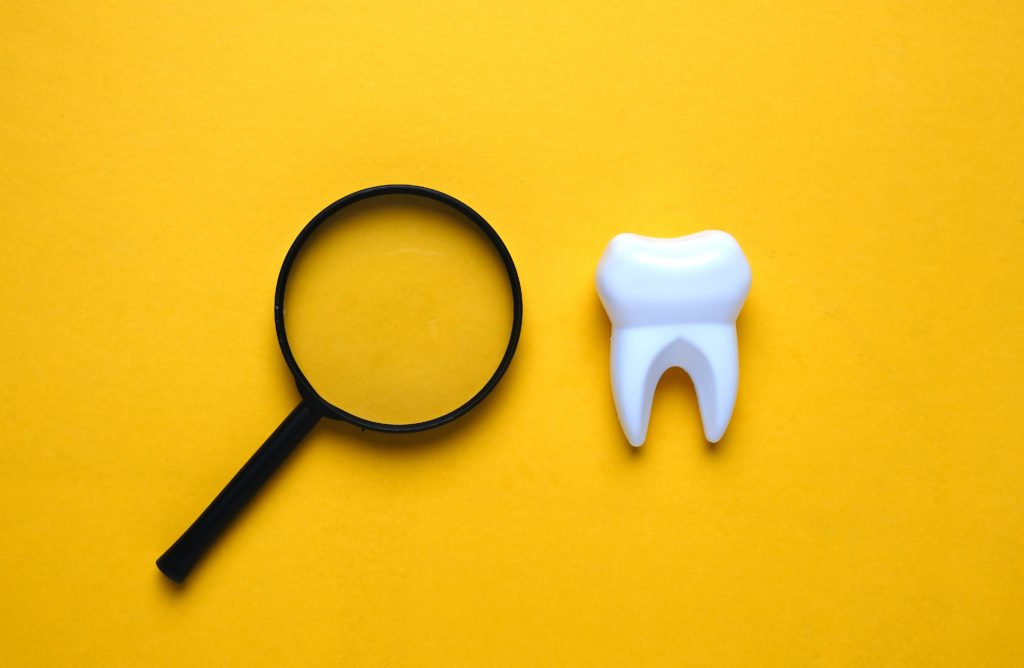 picture of tooth and spyglass demonstrating other health conditions you can find during a Cheadle dental appointment