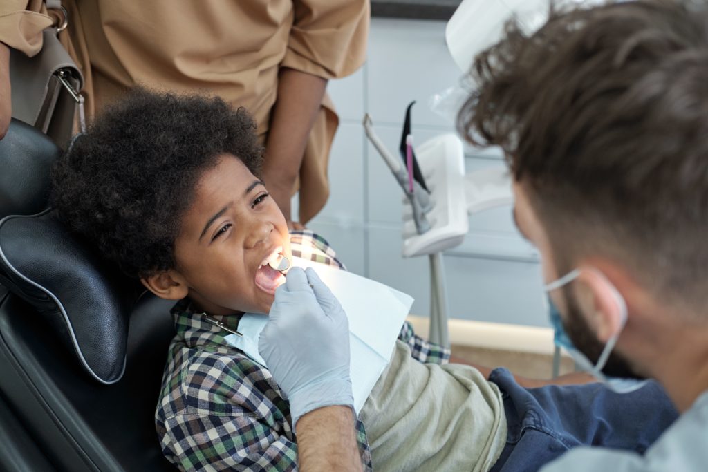 child at dentist who is looking after the child's oral health