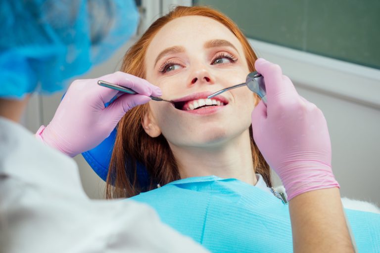 woman getting a drilling dental procedure